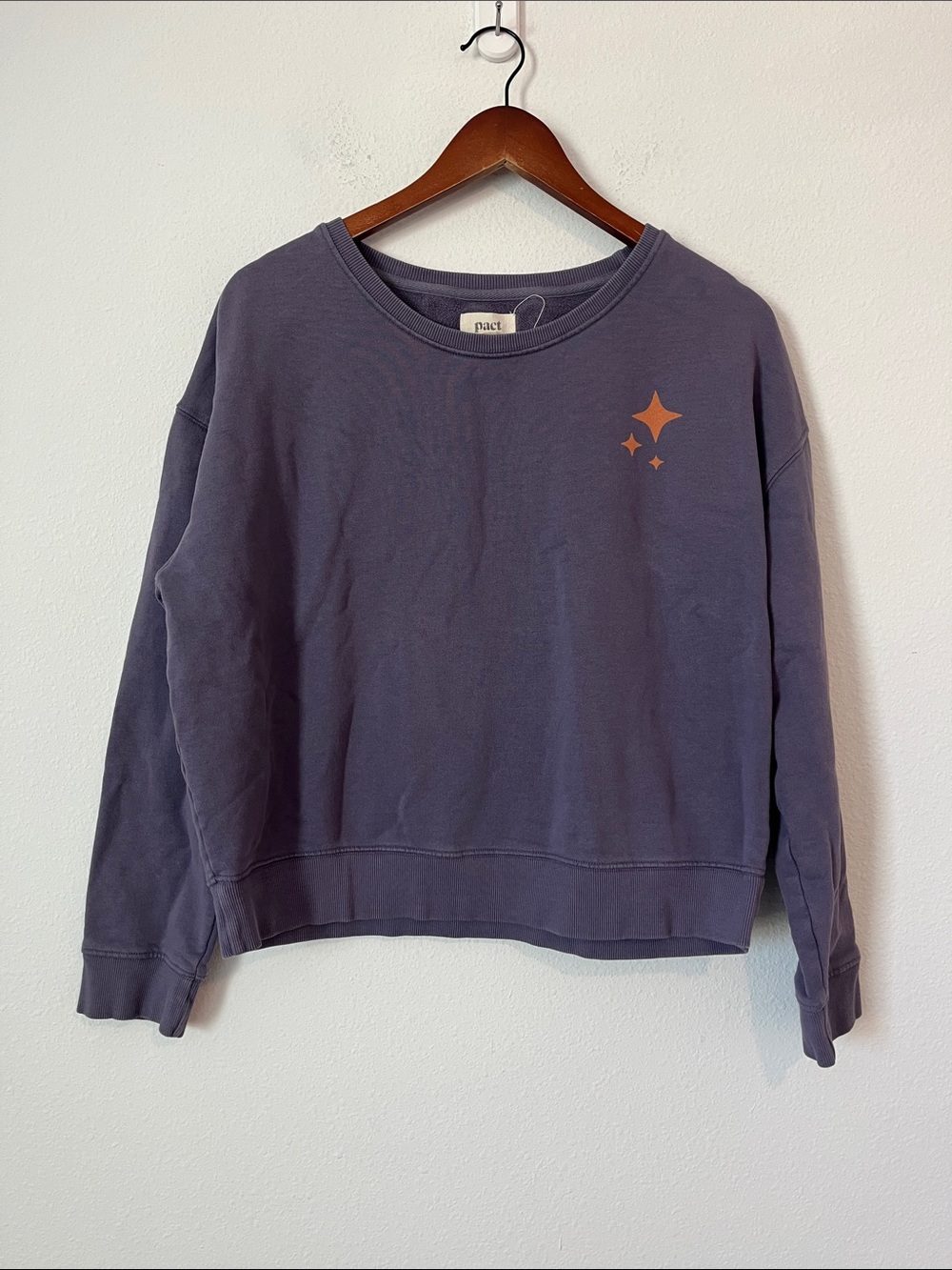 Pact purple crewneck sweatshirt with orange star graphic